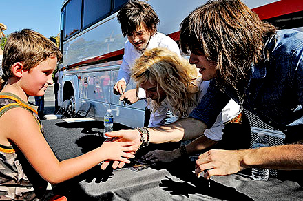 The Band Perry sign an autographs for a young fan