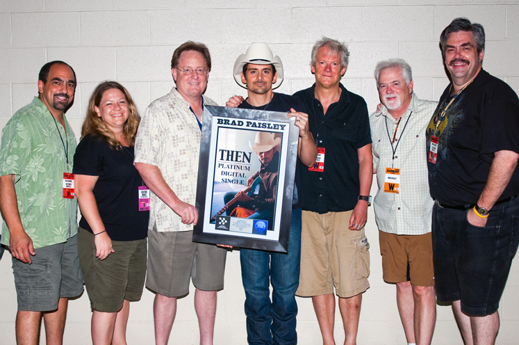 Brad Paisley is presented with a plaque for his Platinum single "Then"