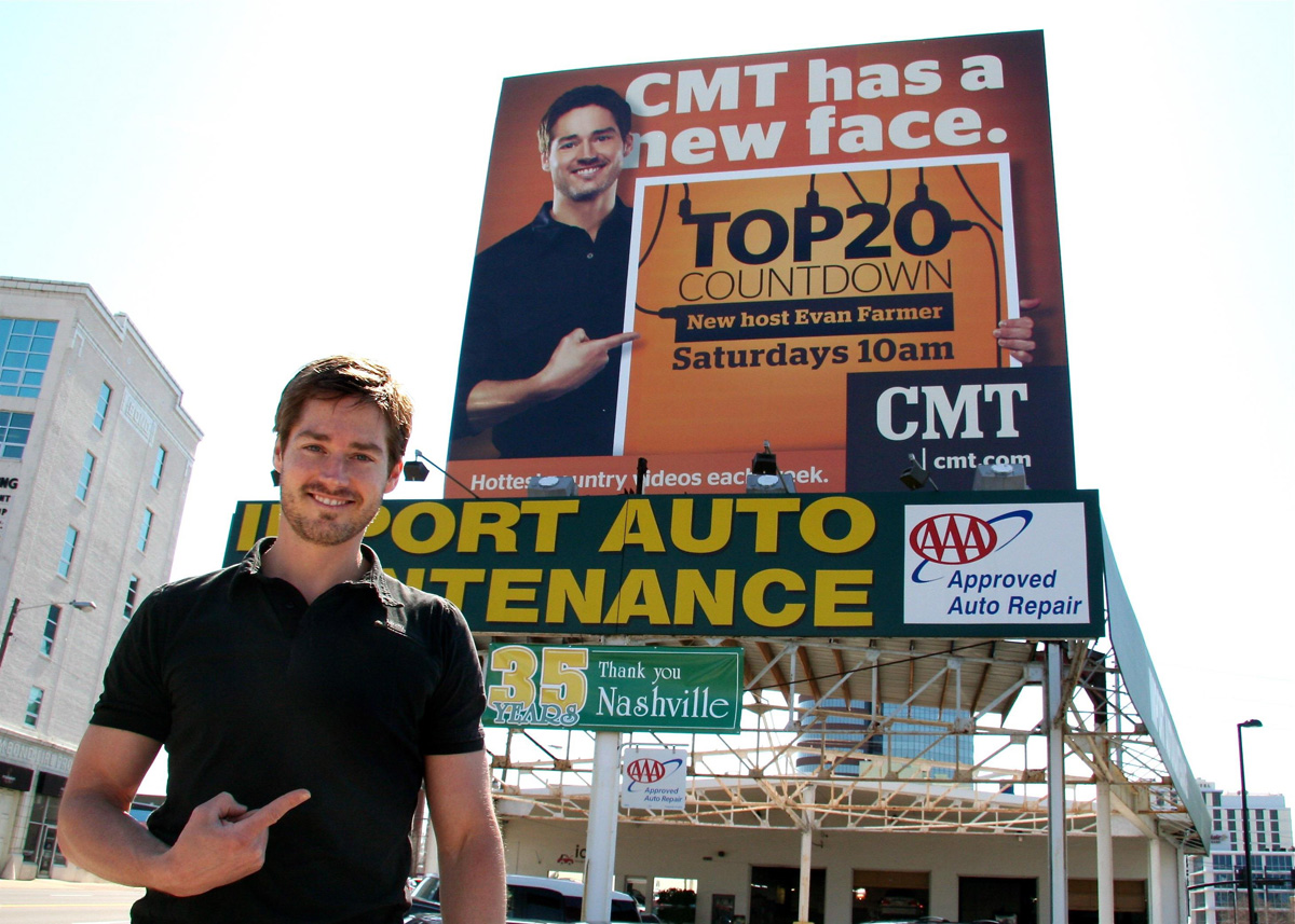 CMT Top 20 host, Evan Farmer, with billboard