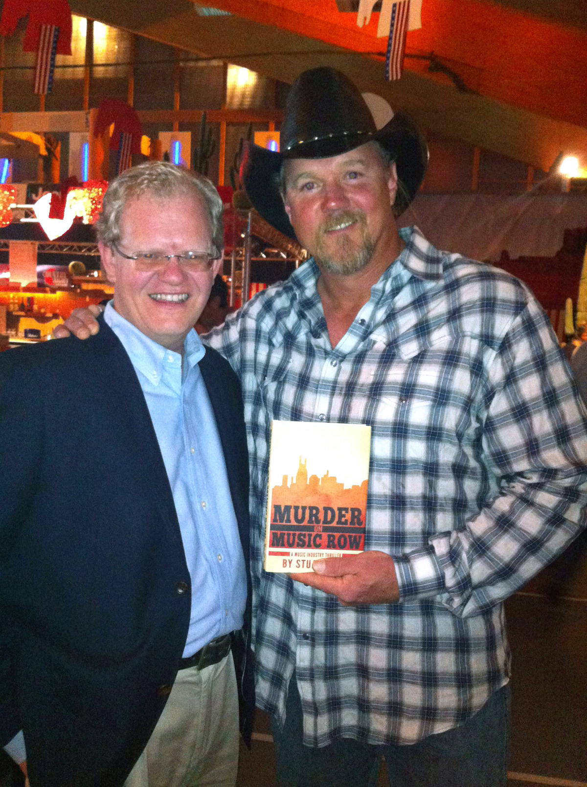 Stuart Dill gives a copy of his book to Trace Adkins