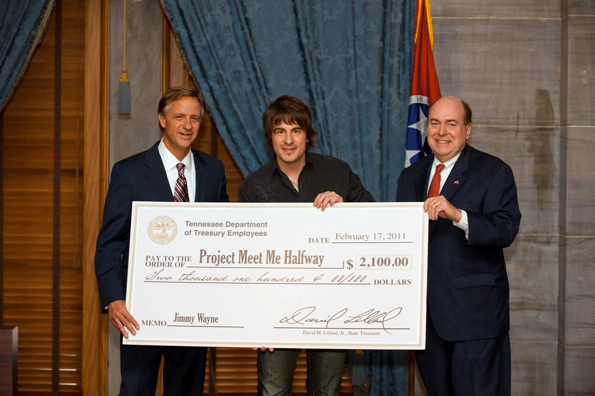 Jimmy Wayne accepts a check for his Meet Me Halfway project