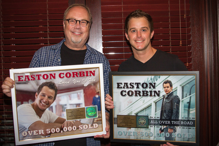 Easton Corbin is presented with two gold plaques